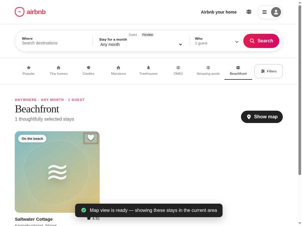 Airbnb stays page with the Saltwater Cottage heart button carrying the browser's native focus outline.